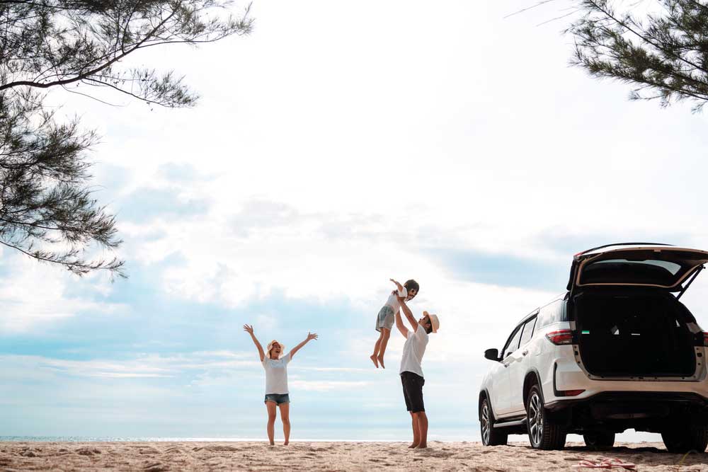 Cadillac on the beach with a family